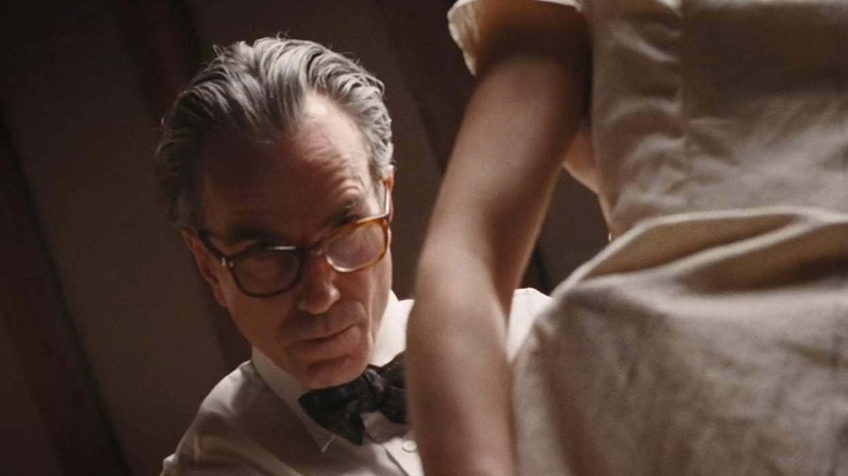 Daniel Day-Lewis as Reynolds Woodcock, adjusting a dress in Phantom Thread