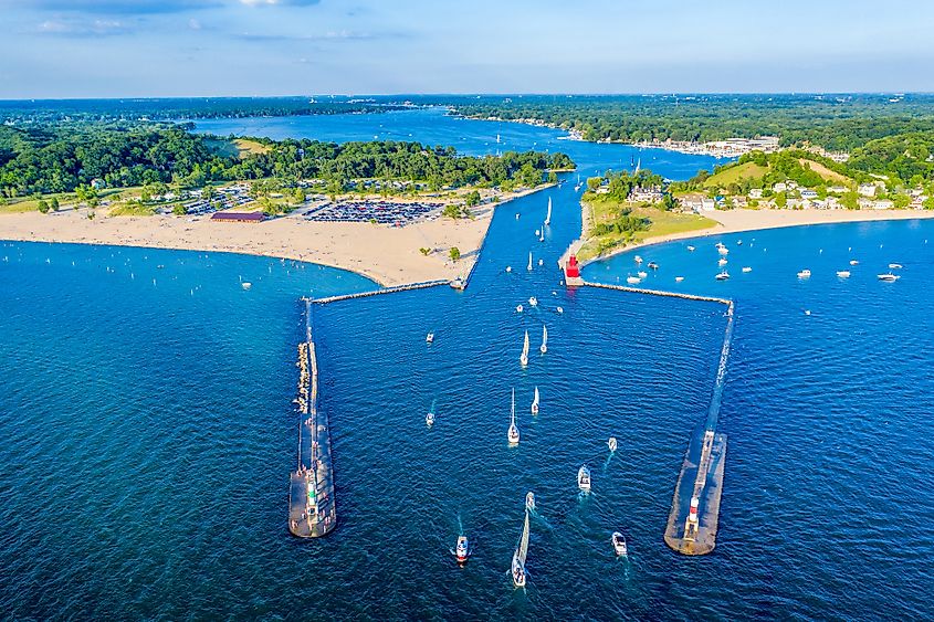 Aerial view of the Holland Harbor Lighthouse, known as the Big Red Lighthouse, at the channel connecting Lake Macatawa with Lake Michigan in Holland State Park, Michigan. 