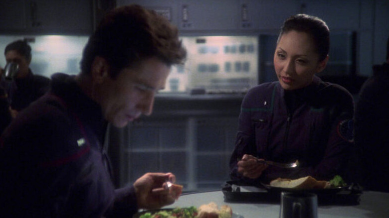 Hoshi Sato (Linda Park) speaks to an inattentive Malcolm Reed (Dominic Keating) over lunch in Star Trek: Enterprise