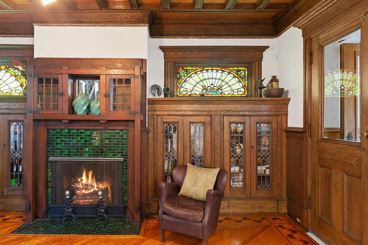 arts and crafts mantel with bookcases on either side