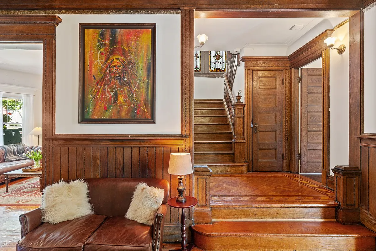 foyer with wainscoting, steps up to stair landing