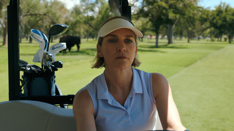 Rhea Seehorn's Carol Sturka driving a golf cart on Pluribus