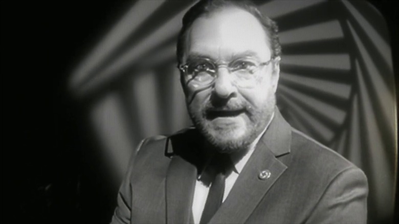 Stephen Root as Hawthorne in a black and white video in The Man in the High Castle