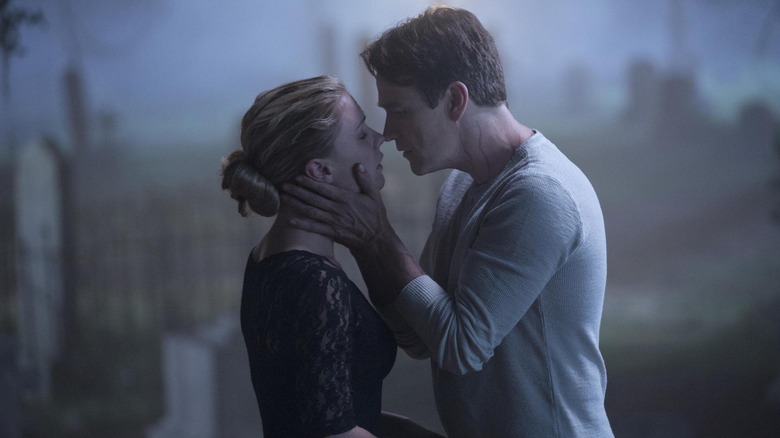 Anna Paquin and Stephen Moyer as Sookie and Bill embracing in a graveyard in True Blood