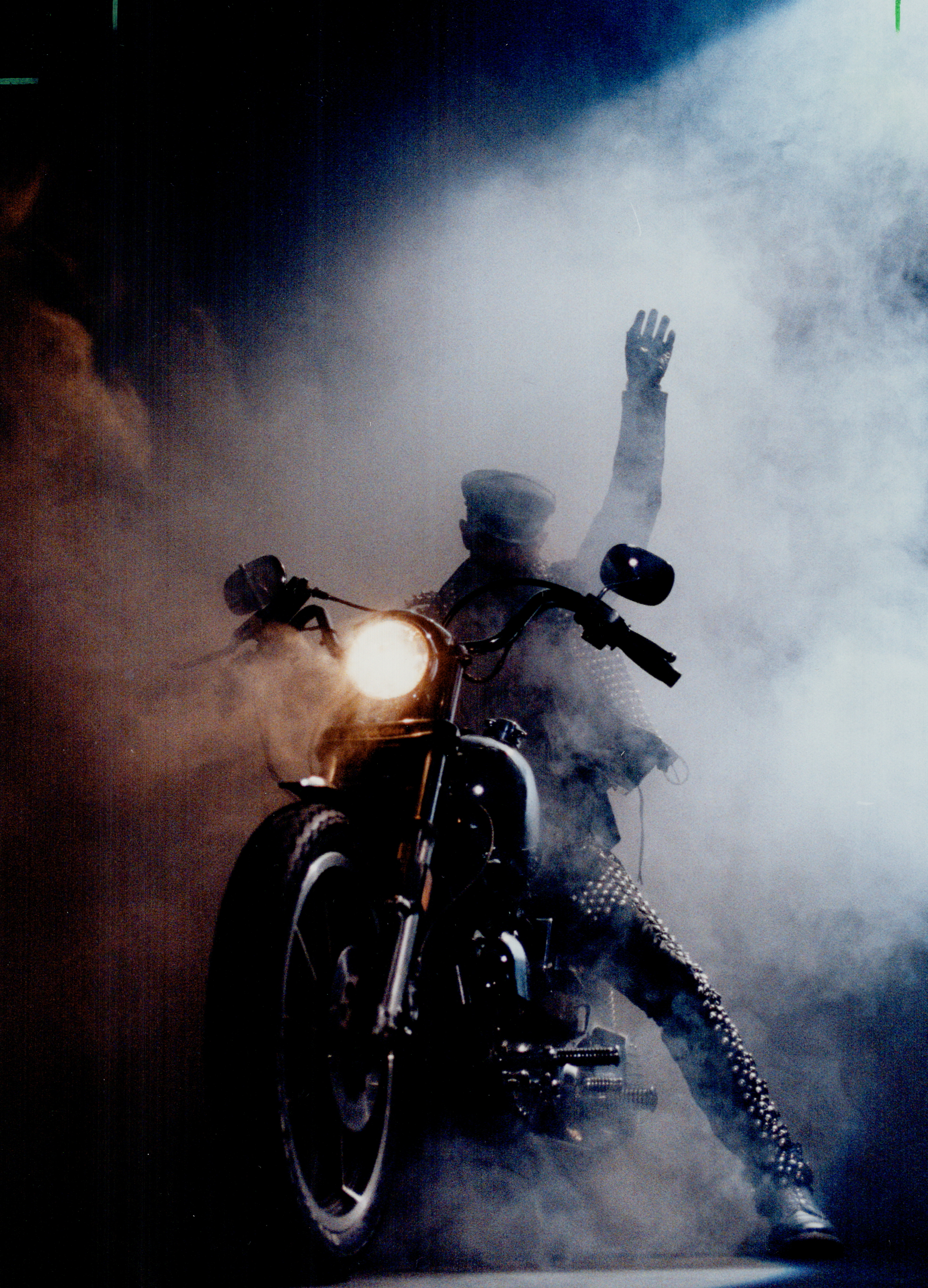 Rob Halford on a bike, on stage, looking epic