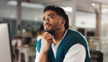 Person looking up while holding their chin.