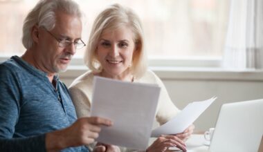 Smiling couple looking at documents together.