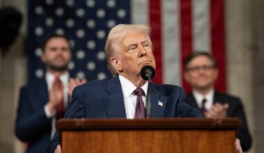 President Donald J. Trump stands at a podium with an American flag in the background.