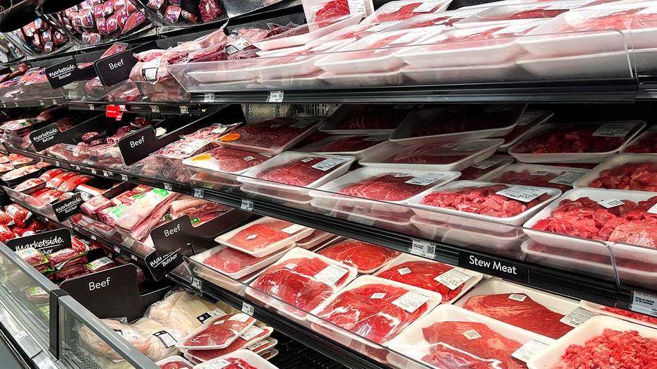 Raw beef sits on grocery cooler shelf