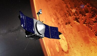 An illustration of a spacecraft with solar panels floating in front of a red planet