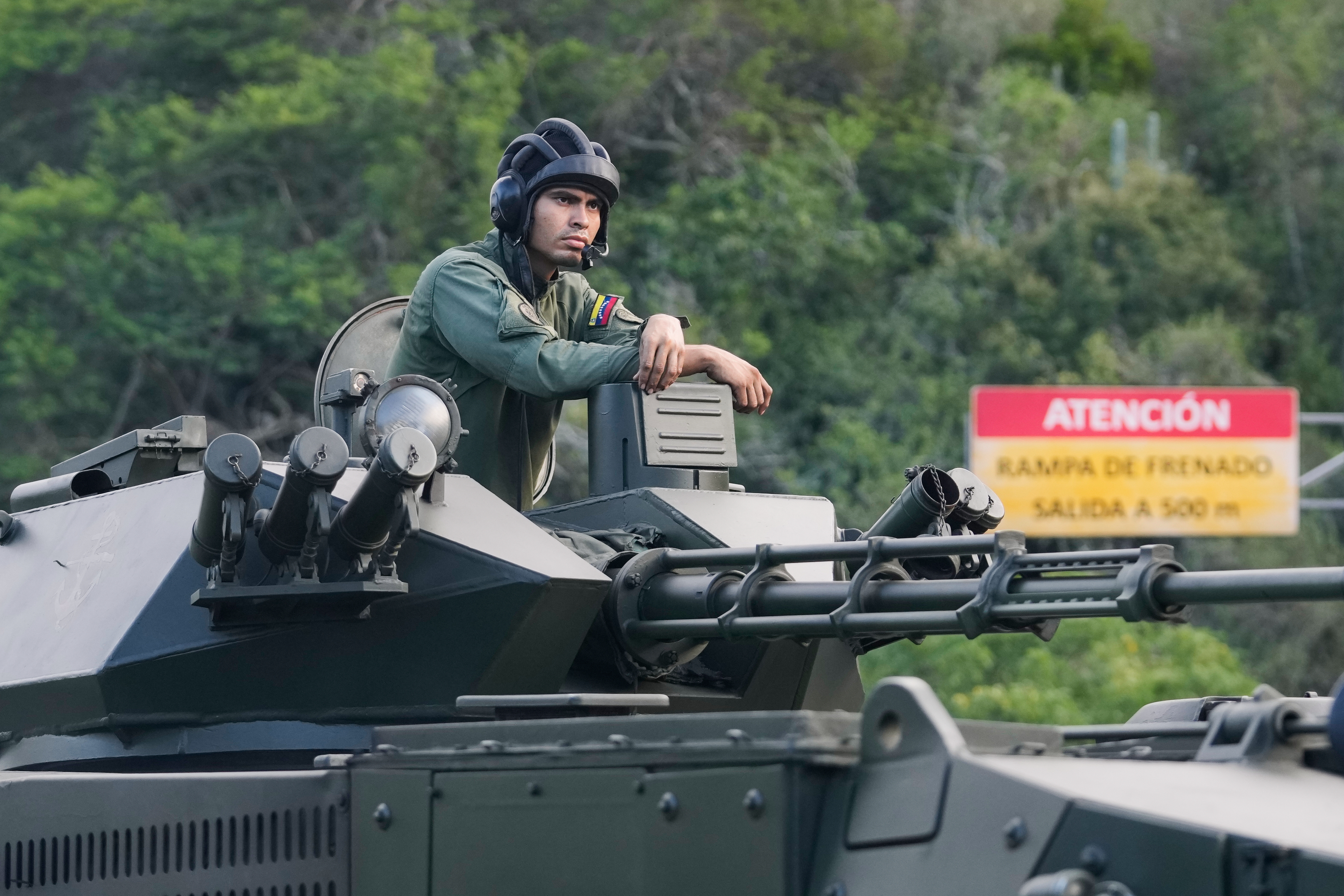 A soldier in an armoured vehicle rolling into Caracas on Sunday