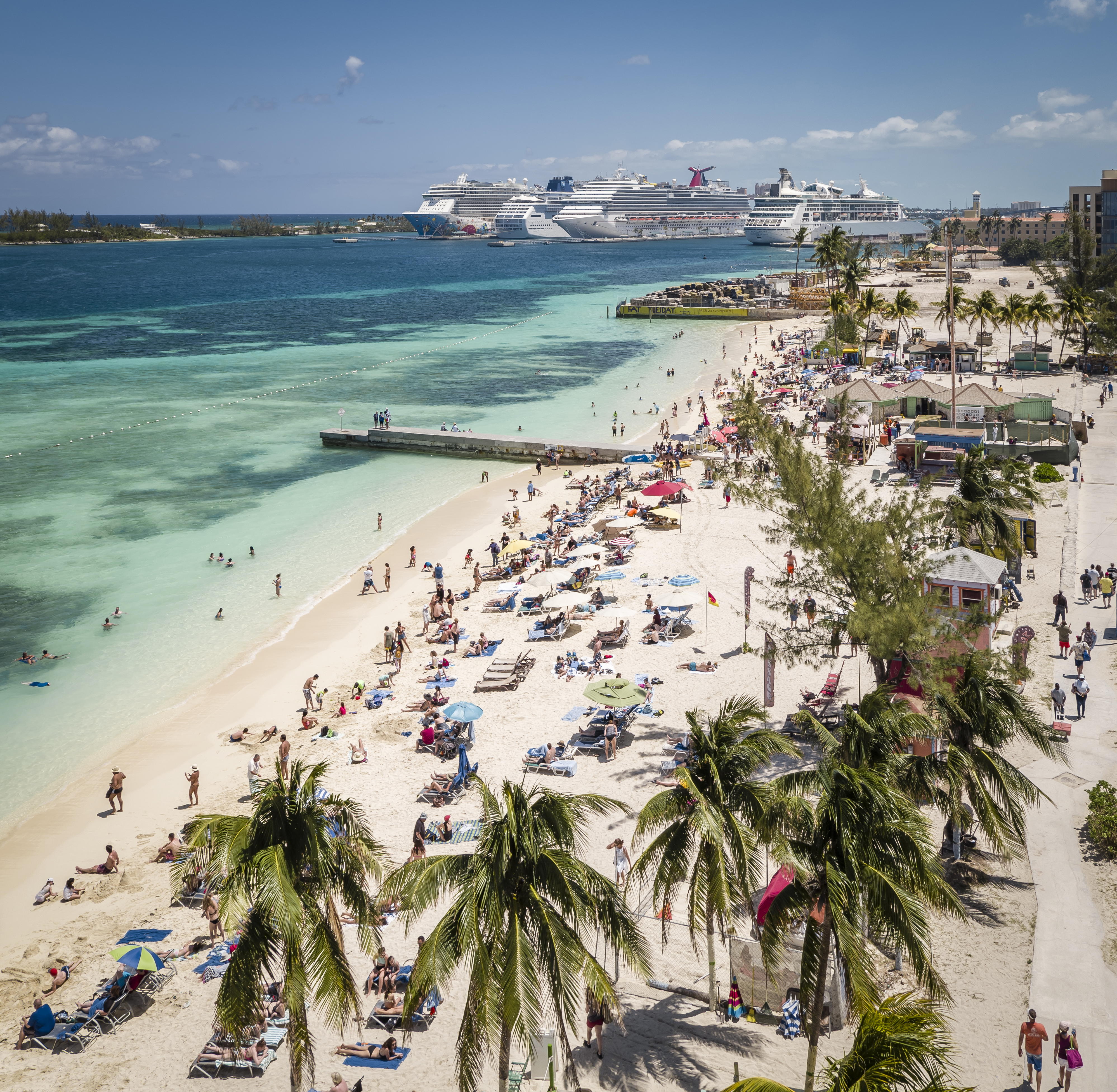 Aerial view of tourists on Junkanoo Beach with cruise ships in the distance, Nassau, Bahamas.