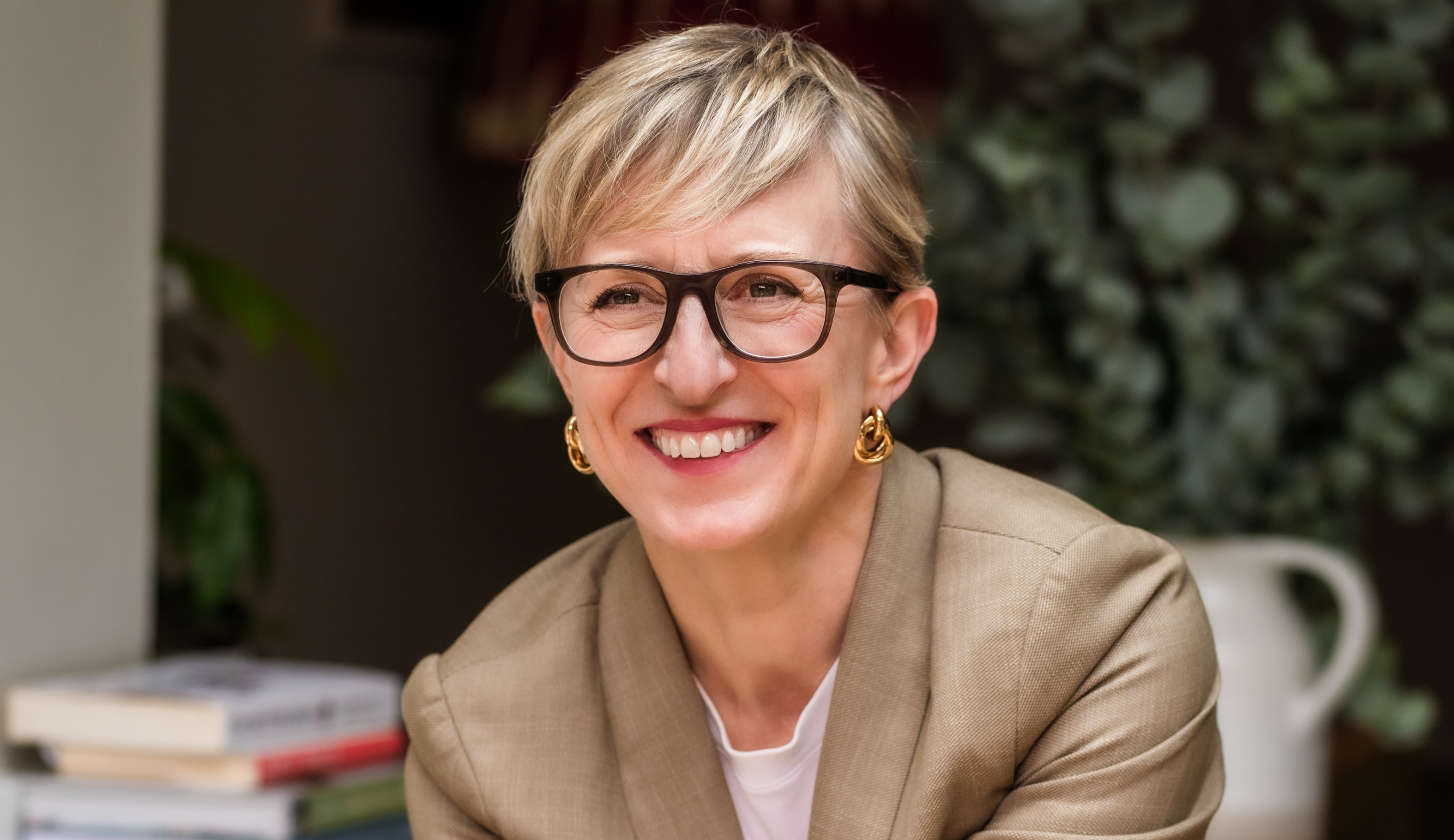 Nicola Shubrook, an Urban Wellness professional, sitting and smiling.