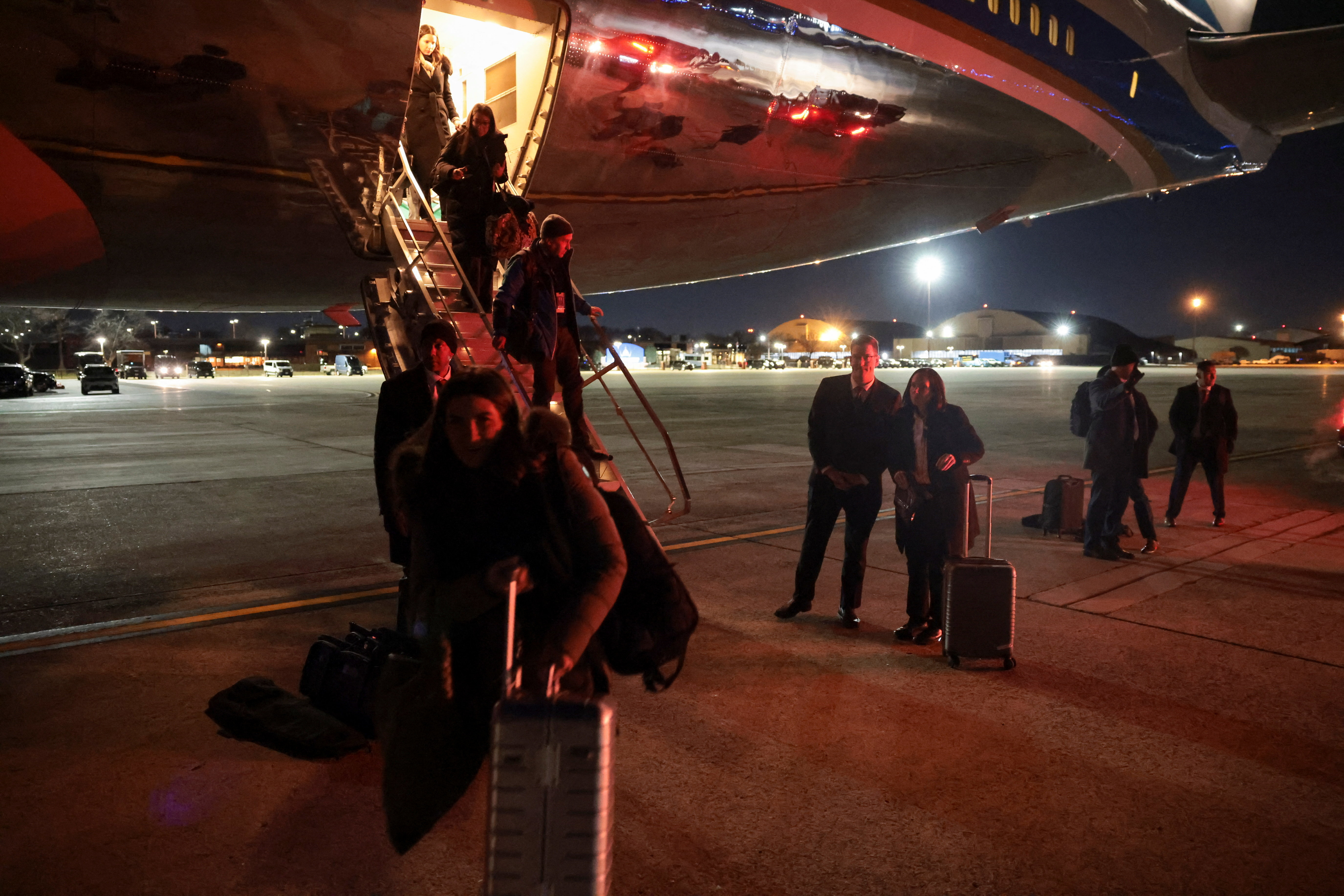 Members of the media deboard Air Force One after returning to Joint Base Andrews