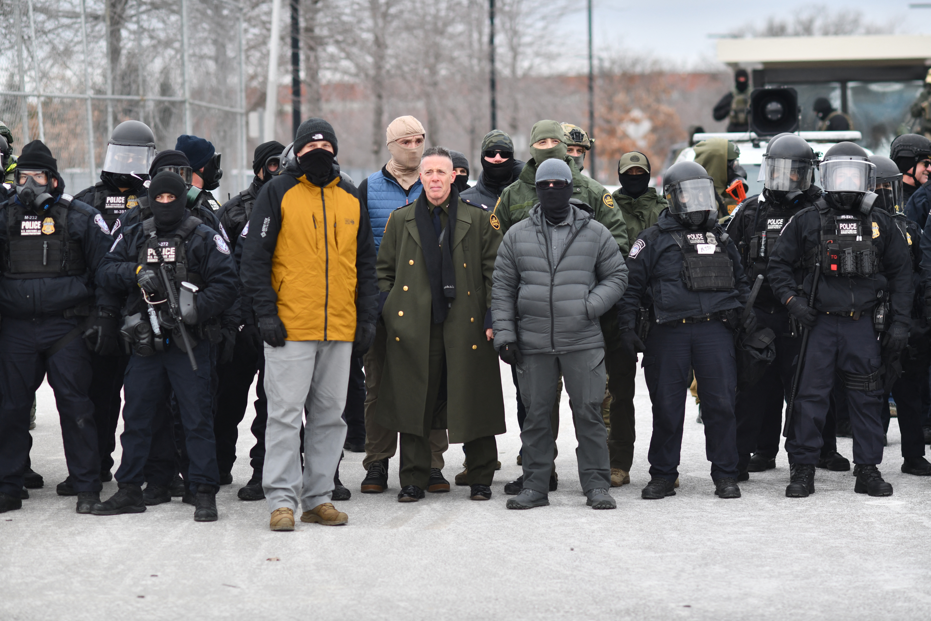 US Customs and Border Protection Commander Gregory Bovino stands flanked by fellow federal agents during a protest against ICE.