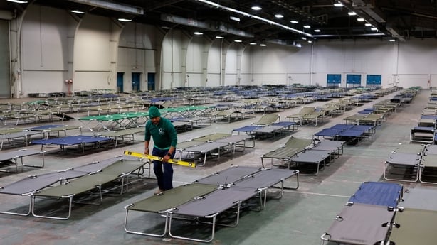 Volunteers prepare cots ahead of a winter storm at Fair Parks Automobile Building in Dallas, Texas.