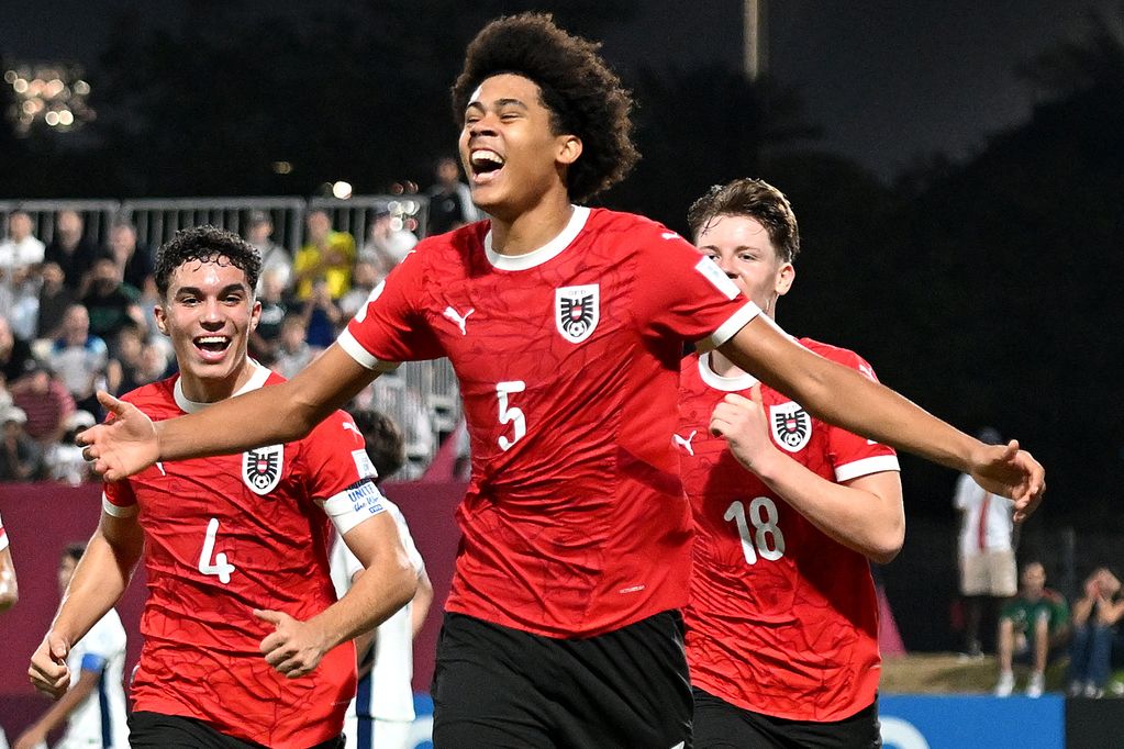 DOHA, QATAR - NOVEMBER 18: Ifeanyi Ndukwe of Austria celebrates scoring his team's fourth goal with teammates during the FIFA Under-17 World Cup Round of 16 match between Austria and England at Aspire Academy on November 18, 2025 in Doha, Qatar. (Photo by Jurij Kodrun - FIFA/FIFA via Getty Images)