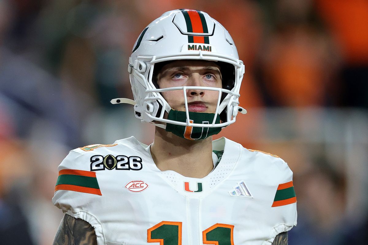 Carson Beck looks up while standing on the field