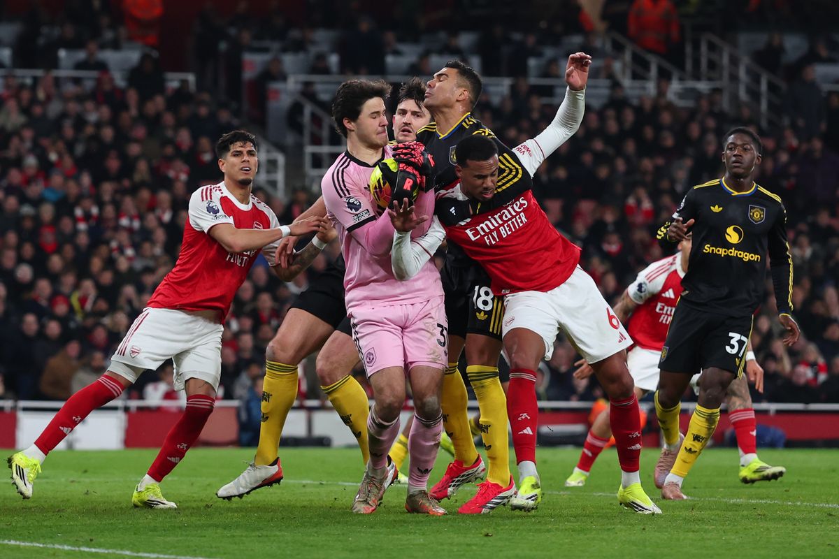 Senne Lammens of Manchester United claims the ball ahead of Gabriel Magalhaes of Arsenal during the Premier League match between Arsenal and Manchester United