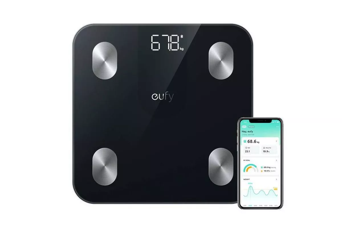 An electronic device displaying a weight reading of 67.0 kilograms, with a sleek black design and silver accents, connected to a smartphone application for health monitoring.