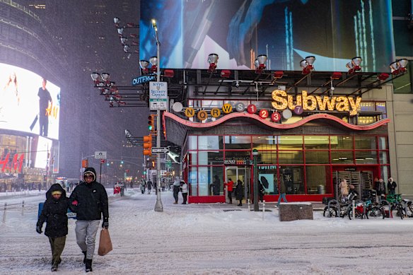 People venture out on a freezing night in New York.