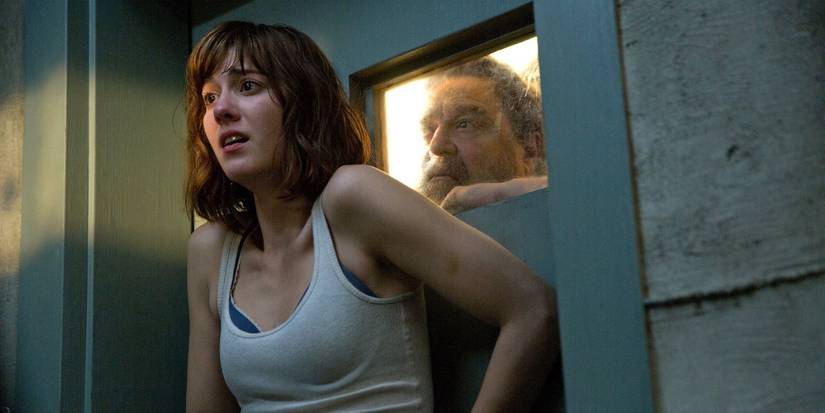 Mary Elizabeth Winstead as Michele by a door, John Goodman as Howard on the other side, 10 Cloverfield Lane.