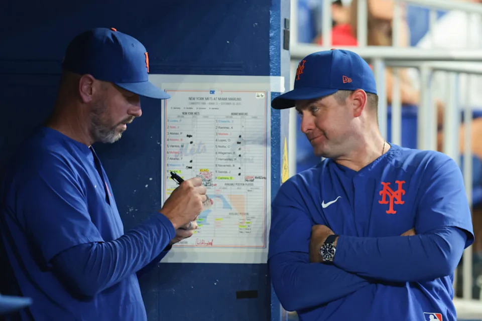 Sep 28, 2025; Miami, Florida, USA; New York Mets manager Carlos Mendoza (64) talks to pitching coach Jeremy Hefner (95) against the Miami Marlins during the eighth inning at loanDepot Park. Mandatory Credit: Sam Navarro-Imagn Images