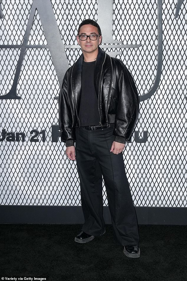 Fashion designer Christian Siriano bundled up in a trendy black leather bomber jacket and square-toed shoes