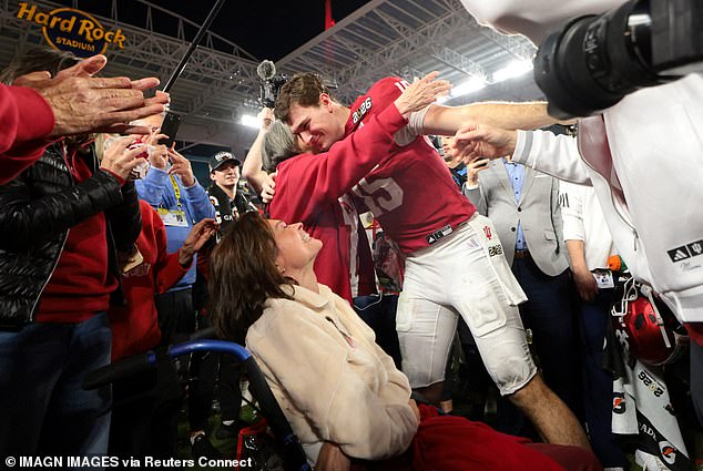 Mendoza ran to find his family on the field among the celebrations after their win over Miami