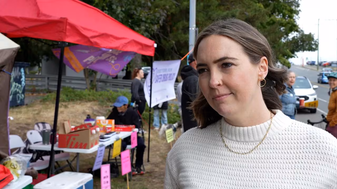 A woman speaks to a camera