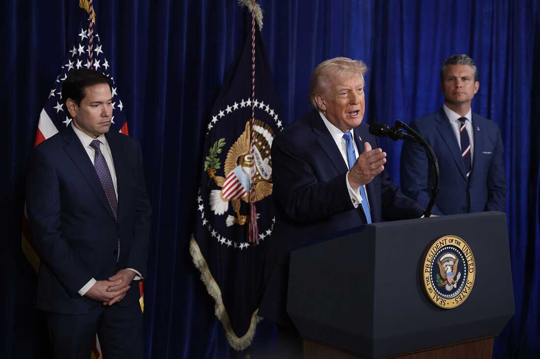 Secretary of State Marco Rubio and Secretary of War Pete Hegseth listen as President  Trump addresses the media during a news conference at his Mar-a-Lago club on January 03, 2026, in Palm Beach, Florida. 