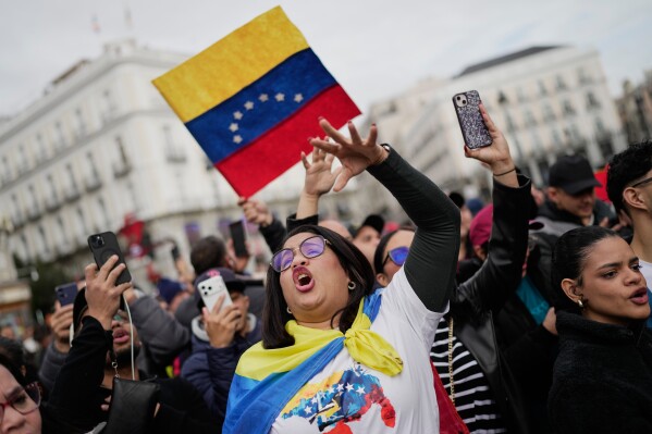 Venezuelan Wiliana Flores celebrates in Madrid after U.S. President Donald Trump announced that Venezuelan President Nicolás Maduro had been captured and flown out of the country on Saturday, Jan. 3, 2026. (AP Photo/Bernat Armangue)