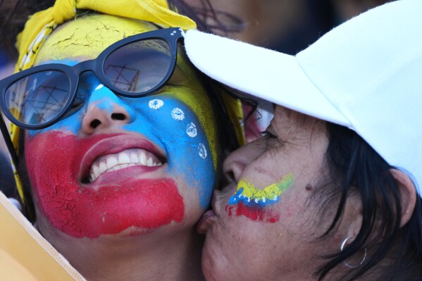 People celebrate at the Obelisk in Buenos Aires, Argentina, Saturday, Jan. 3, 2026, after U.S. President Donald Trump announced that President Nicolas Maduro had been captured and flown out of Venezuela. (AP Photo/Natacha Pisarenko)