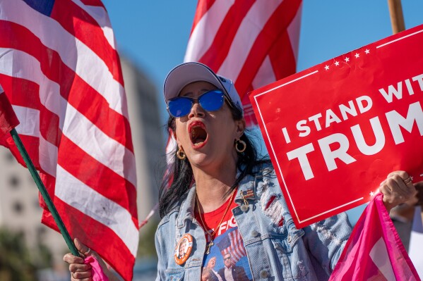 Maribel Gonzalez celebrates outside Versailles Cuban Cuisine after President Donald Trump announced President Nicolás Maduro had been captured and flown out of Venezuela, in Miami, Saturday, Jan. 3, 2026. (AP Photo/Jen Golbeck)