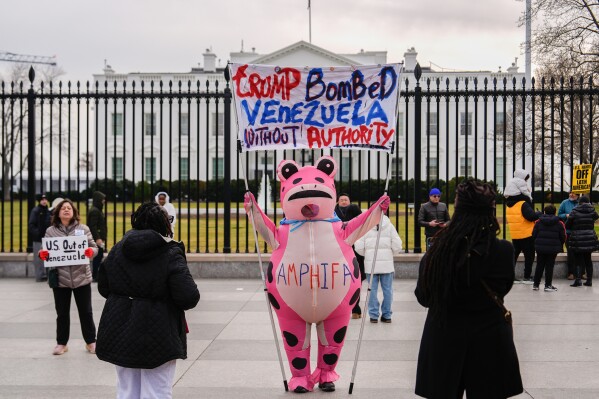 Nadine Siler, of Waldorf, Md., dressed in a pink frog costume, attends a rally outside the White House in Washington, Saturday, Jan. 3, 2026, after the U.S. captured Venezuelan President Nicolás Maduro and first lady Cilia Flores in a military operation. (AP Photo/Julia Demaree Nikhinson)