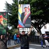 Supporters of Venezuela's current and former president, Nicolas Maduro and the late Hugo Chavez, hold posters with their images in Caracas on Saturday.