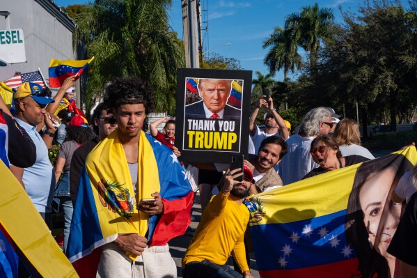 People celebrate after President Donald Trump announced Venezuelan President Nicolás Maduro had been captured and flown out of the country, in Doral, Fla., Saturday, Jan. 3, 2026. (AP Photo/Jen Golbeck)