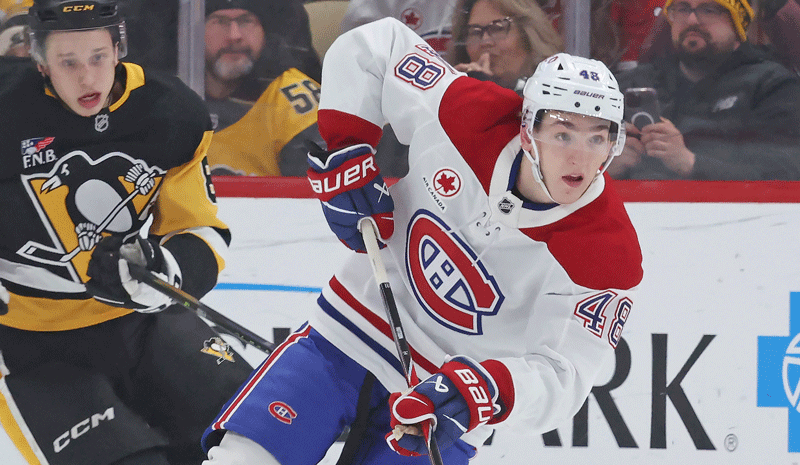 Montral Canadiens defenseman Lane Hutson (48) moves the puck ahead of Pittsburgh Penguins center Ben Kindel (81) during the second period at PPG Paints Arena.