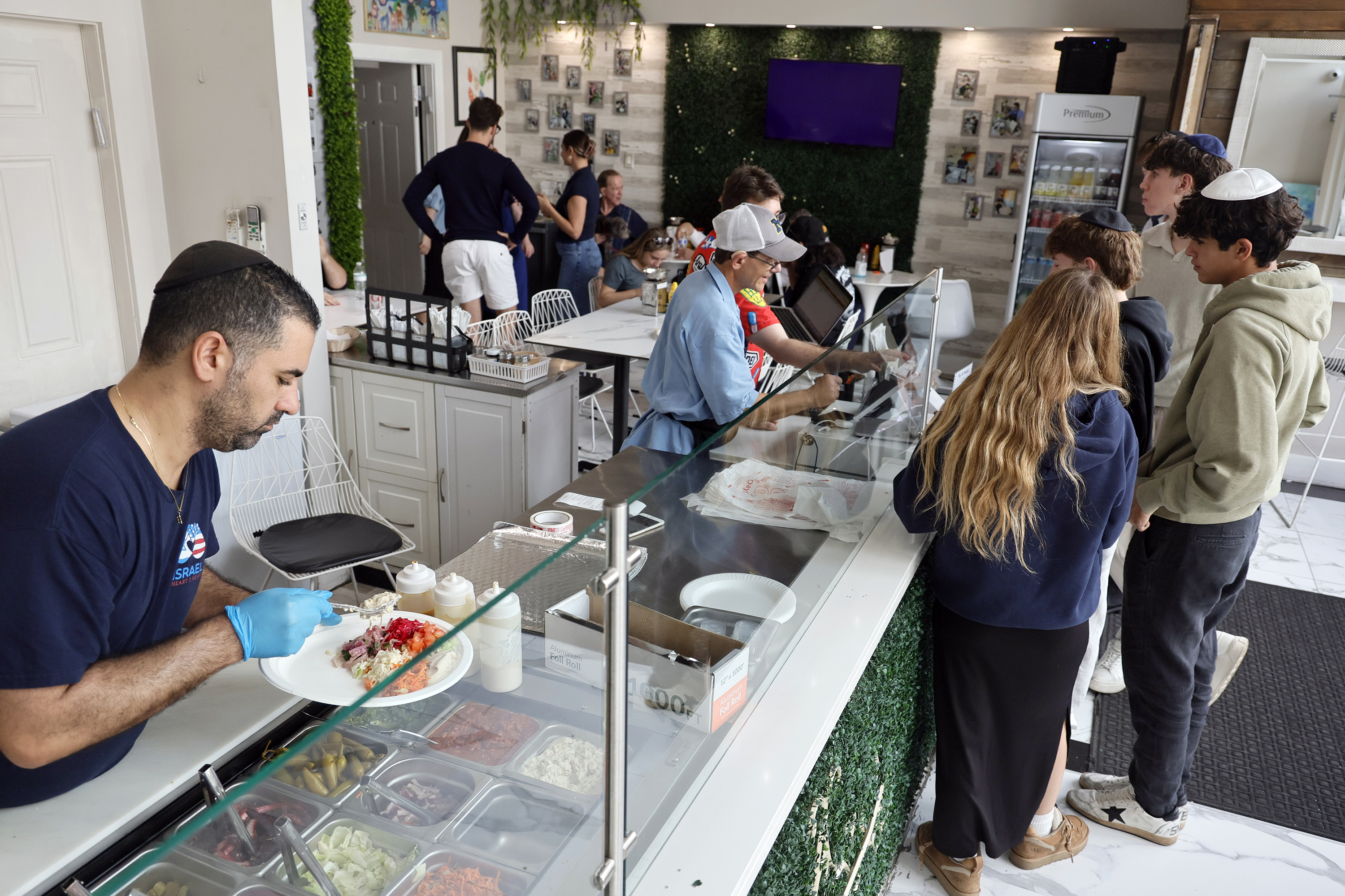 Cook Tomer Levi plates a customerâs order at The Friendship...