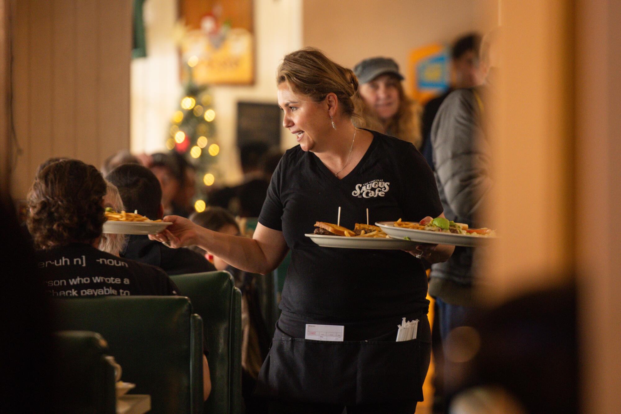 Michaela Vuong serves food at the Original Saugus Cafe.