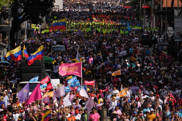 Government supporters gather for a women's march to demand the return of Venezuelan President Nicolas Maduro in Caracas, Venezuela, Tuesday, Jan. 6, 2026, three days after U.S. forces captured him and his wife. (AP Photo/Matias Delacroix)