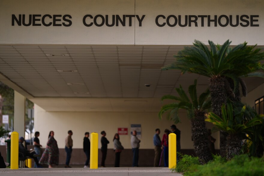 A line forms at the Nueces County Courthouse in Corpus Christi, Texas, as jury selection continues in the trial for former Uvalde school district police officer Adrian Gonzales, Monday, Jan. 5, 2026.