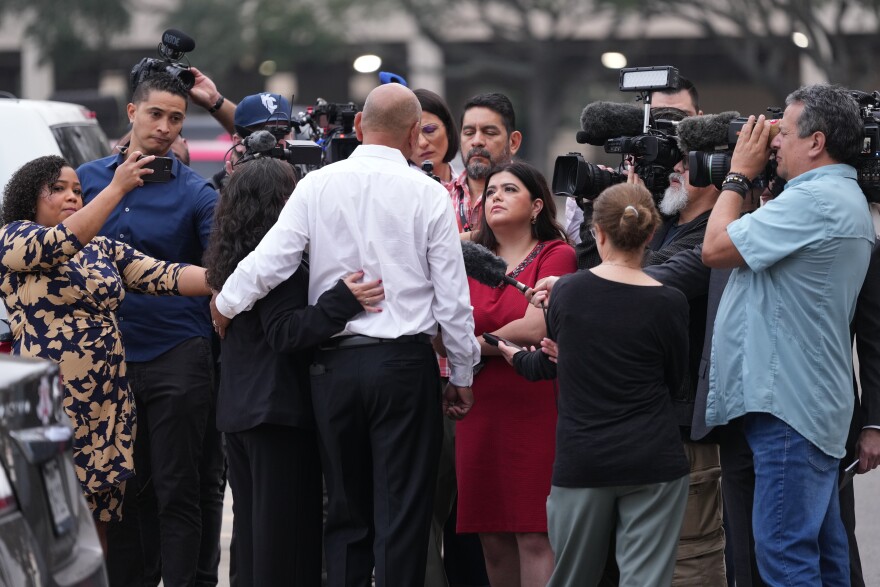 Family member Jesse Rizo, center, talks to the media before the trial for former Uvalde school district police officer Adrian Gonzales at the Nueces County Courthouse in Corpus Christi, Texas, Tuesday, Jan. 6, 2026.