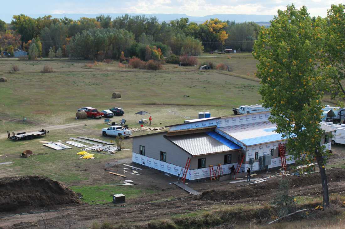 A large, one-story building under construction is photographed from above.