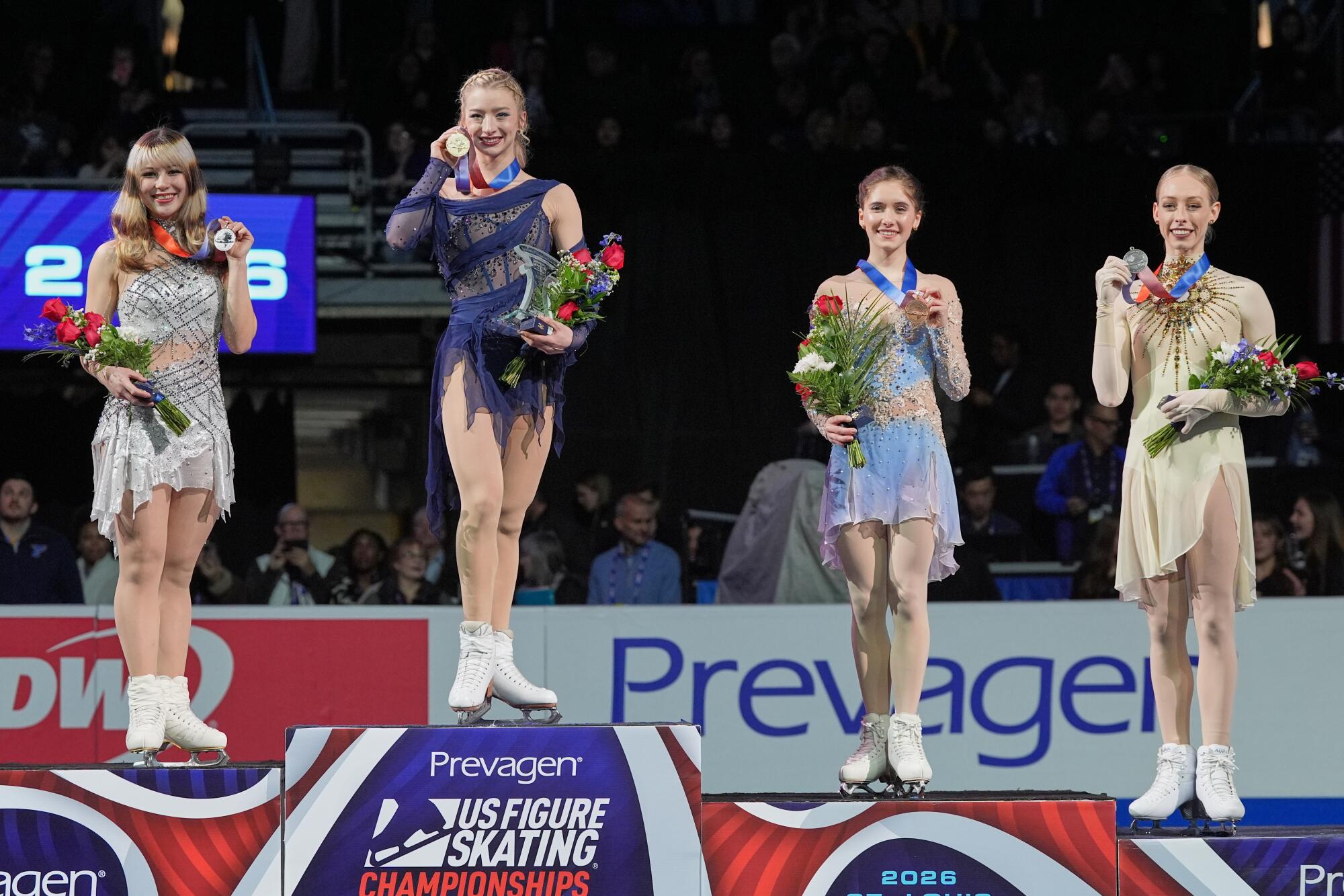 U.S. figure skaters (from left) Alysa Liu, Amber Glenn, Isabeau Levito and Bradie Tennell pose with their medals.