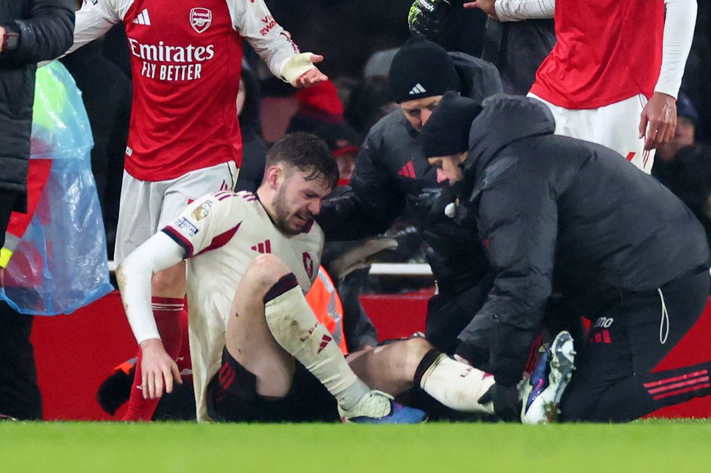 Conor Bradley receives treatment after going down injured during Liverpool's game against Arsenal