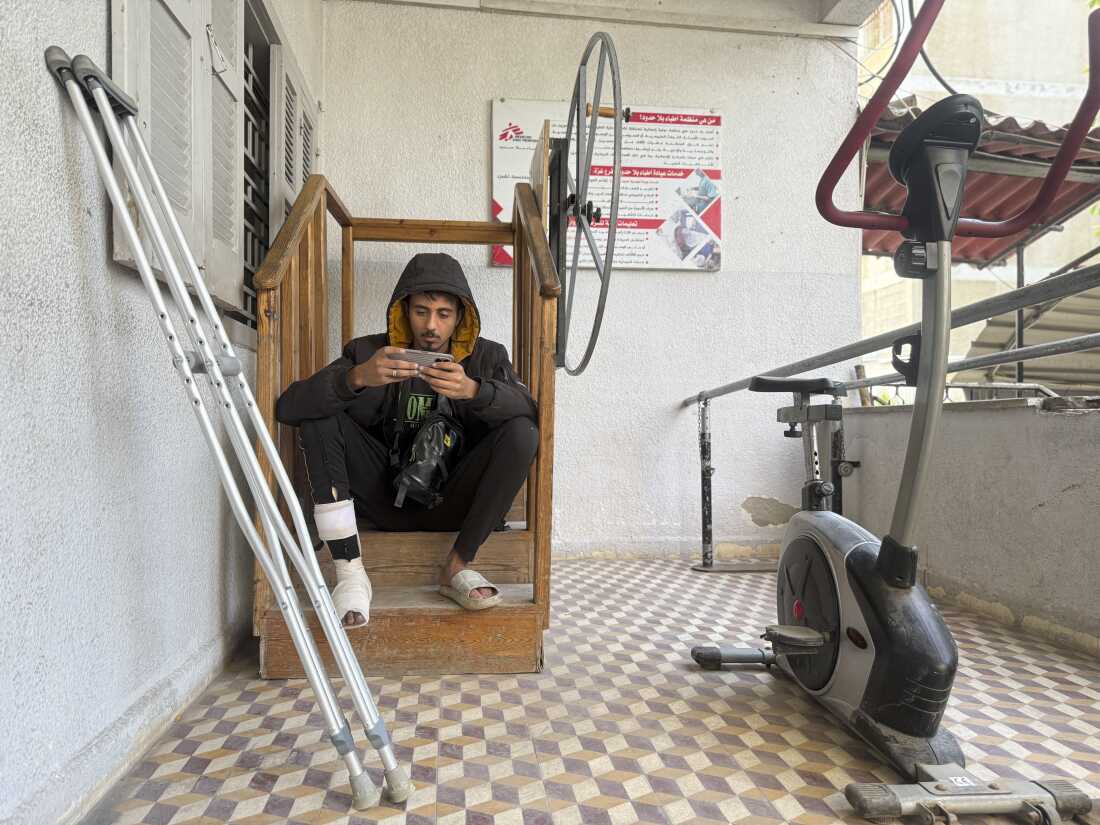A Palestinian man wounded in the war sits near a stationary bike used for physiotherapy at MSF’s clinic in Gaza City on Dec. 31, 2025.
