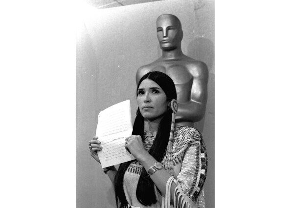 FILE - Sacheen Littlefeather appears at the Academy Awards ceremony to announce that Marlon Brando was declining his Oscar as best actor for his role in "The Godfather," on March 27, 1973. (AP Photo, File)