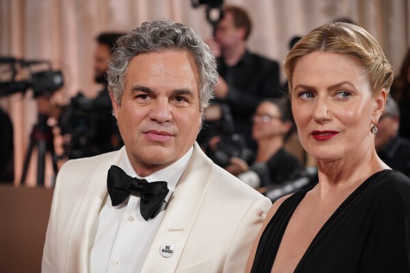 Mark Ruffalo, left, and Sunrise Coigney arrive at the 83rd Golden Globes on Sunday, Jan. 11, 2026, at the Beverly Hilton in Beverly Hills, Calif. (Photo by Jordan Strauss/Invision/AP)