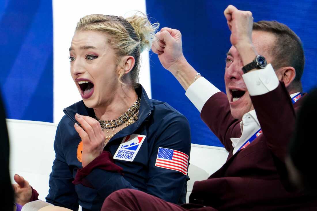Amber Glenn embraces her coach Damon Allen after her short program scored a record 83.05 at the U.S. Figure Skating Championships.